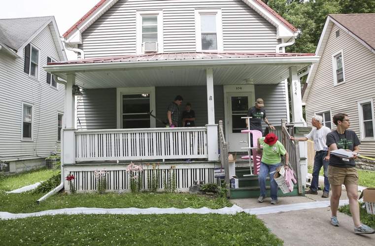 olunteers clear off a porch that is slated to be replaced during Matthew 25's Transform Week in Cedar Rapids on Wednesday, June 