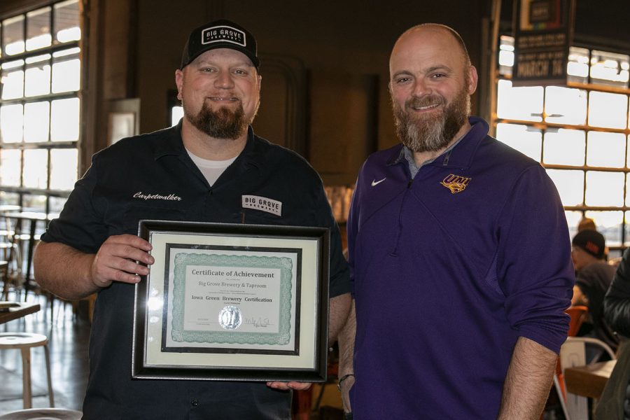 Big Grove two men side by side, one holding Big Grove's Certificate of Achievement