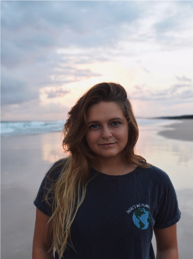 Hanna Malzenski standing on beach at sunset