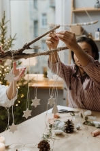 hanging white stars on strings from decorative branch