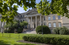 Photo of Schaeffer Hall in the spring with leaves