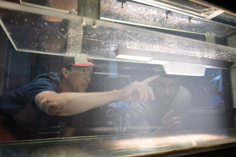 Student looking through a tank of water