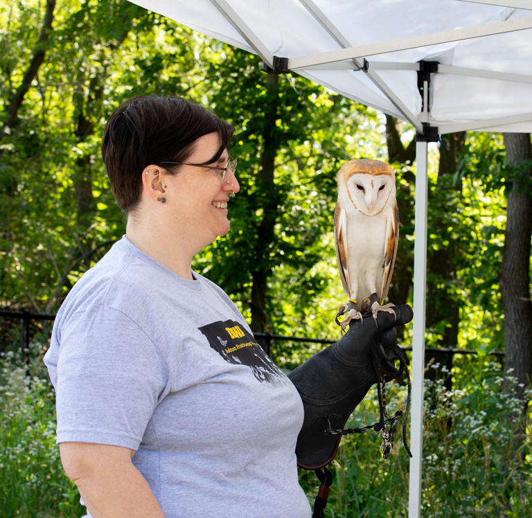 UI WILD staff holding a small owl