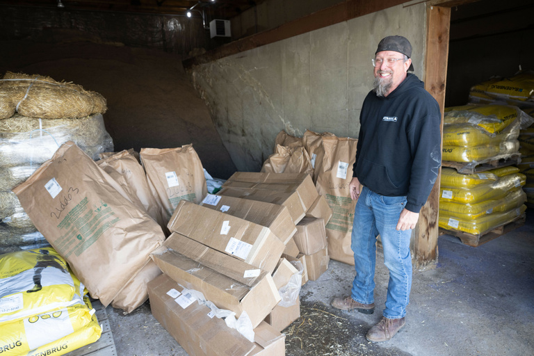Andy Dahl standing near bags of tree samplings to be planted in Miyawaki Forest