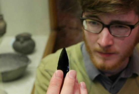 museum studies student looking at arrowhead