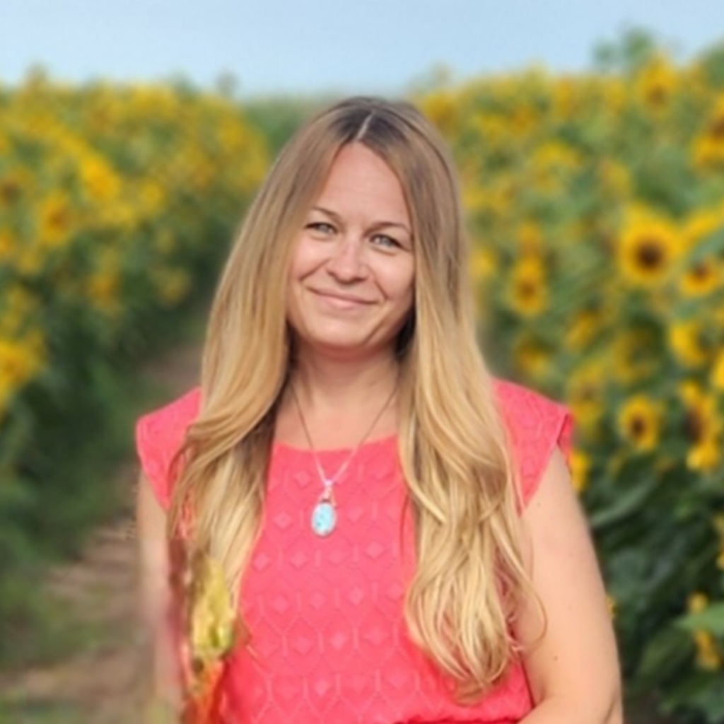 Beth MacKenzie in a field of sunflowers