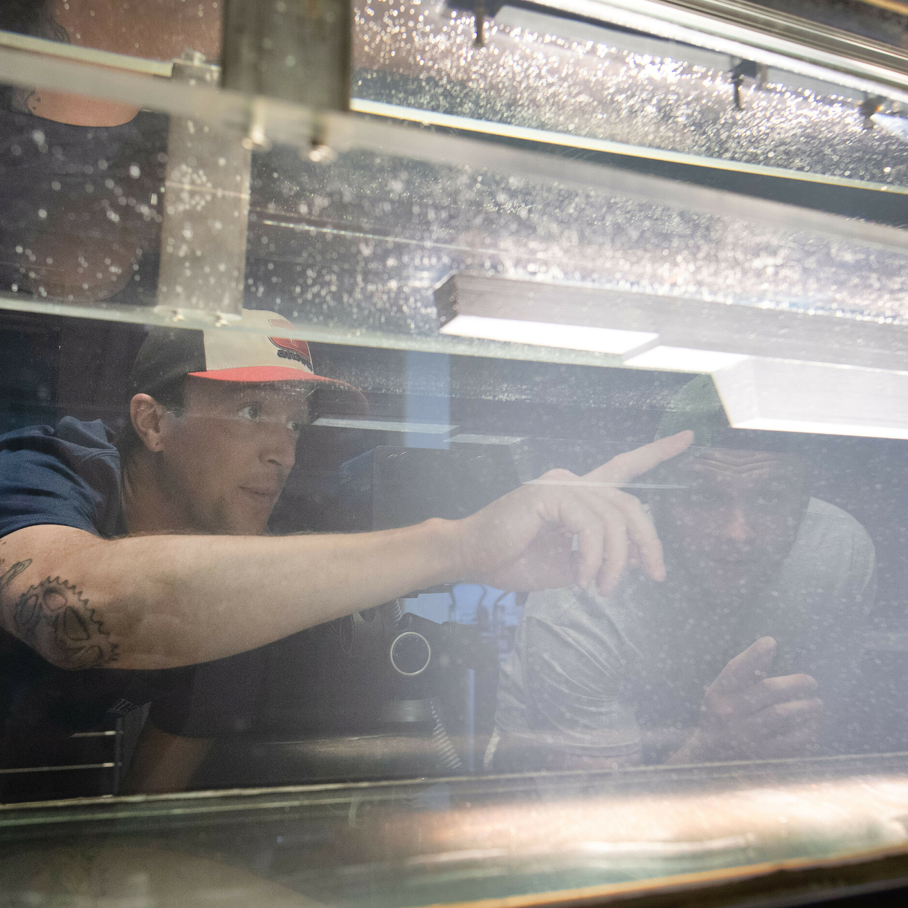 Student looking through a tank of water