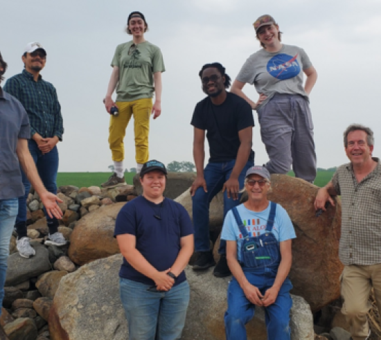 Researchers standing on boulders