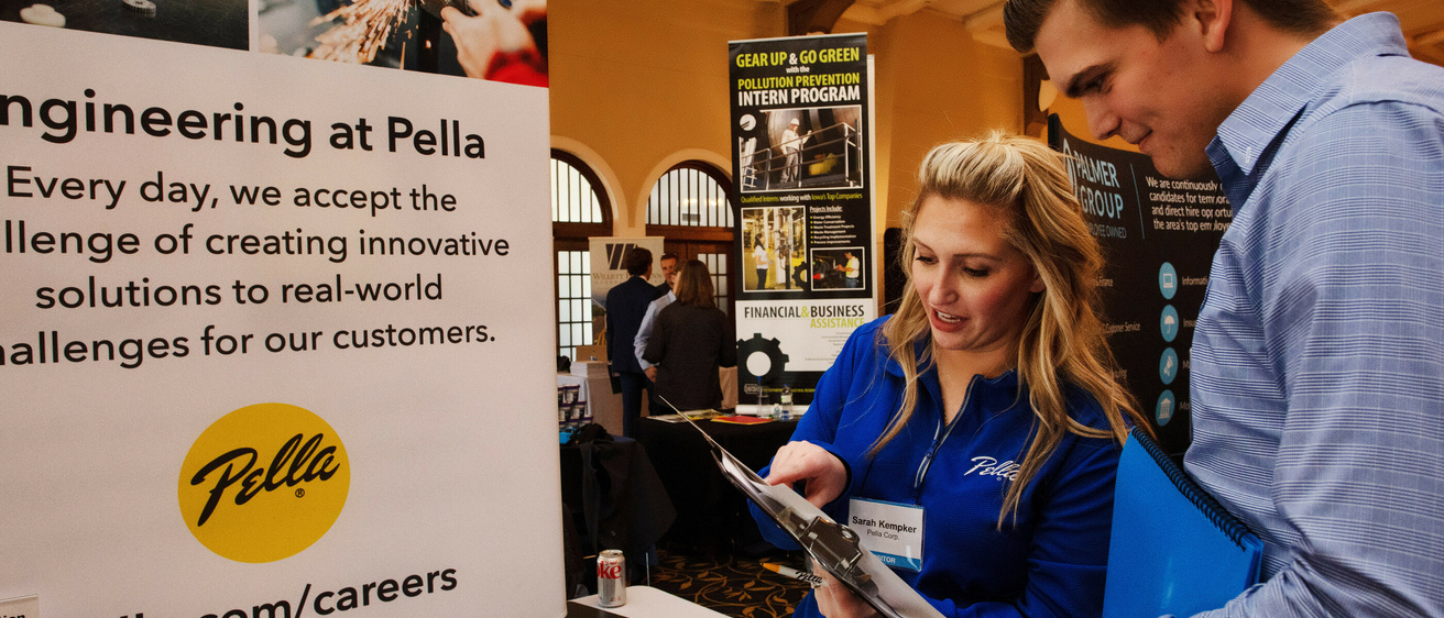Students talking with a woman at the engineering career fair
